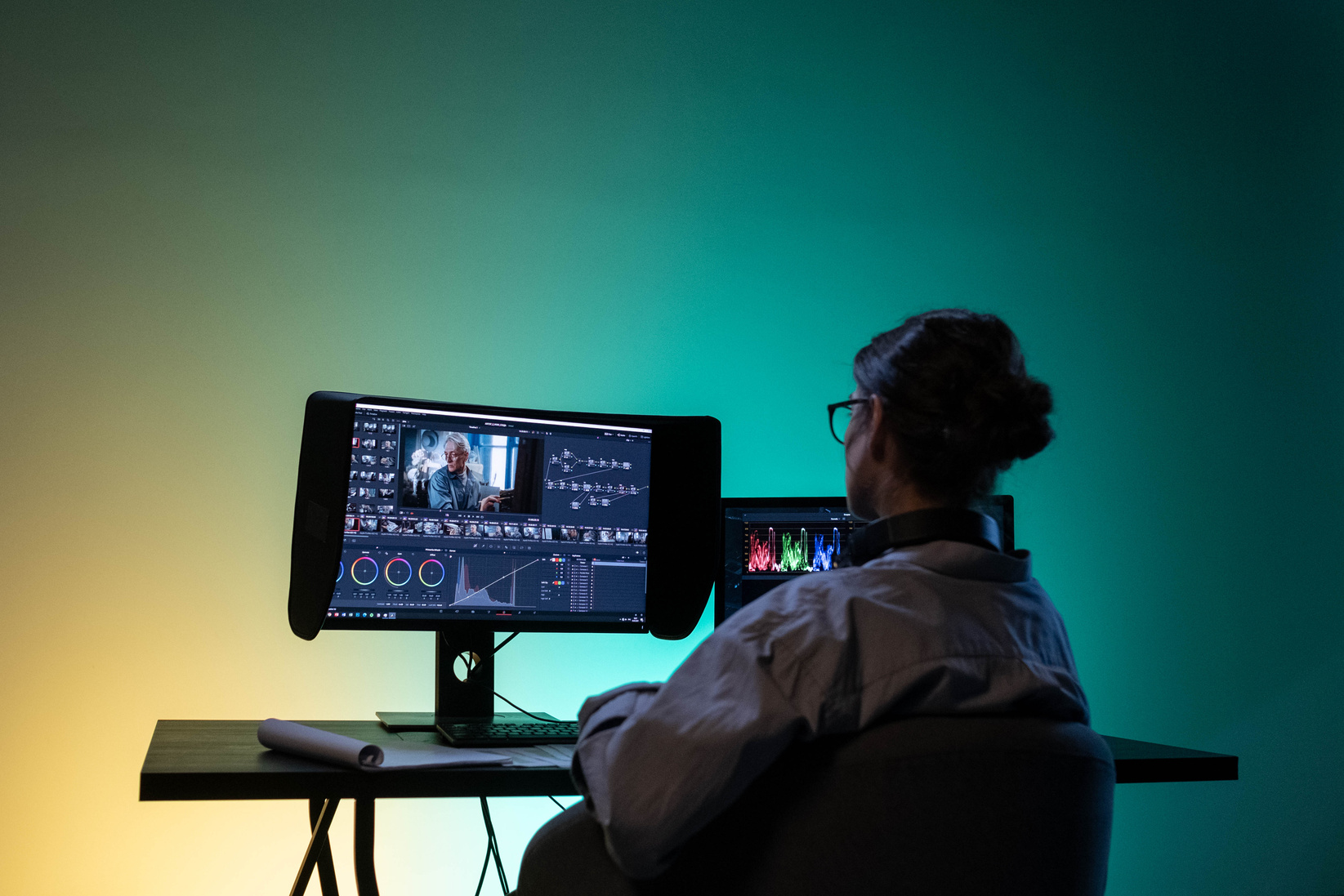 Backview of a Female Editor working on a Computer